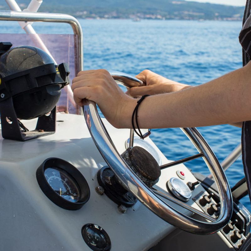 a person sitting on a boat in the water