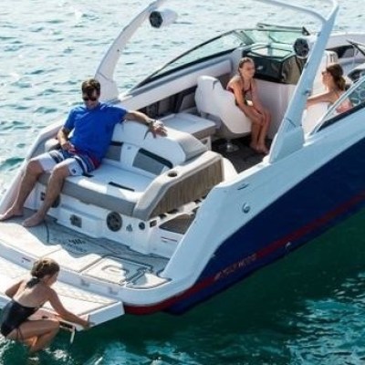 a person riding on the back of a boat in the water